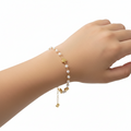 Pulsera infantil,  perlas y corazónes.